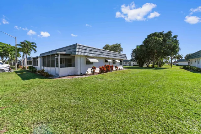 a view of a house with a backyard porch and sitting area