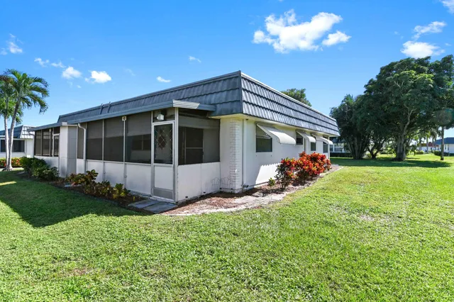 a view of a house with a yard and garden