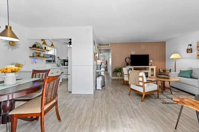 a dining room with furniture and wooden floor