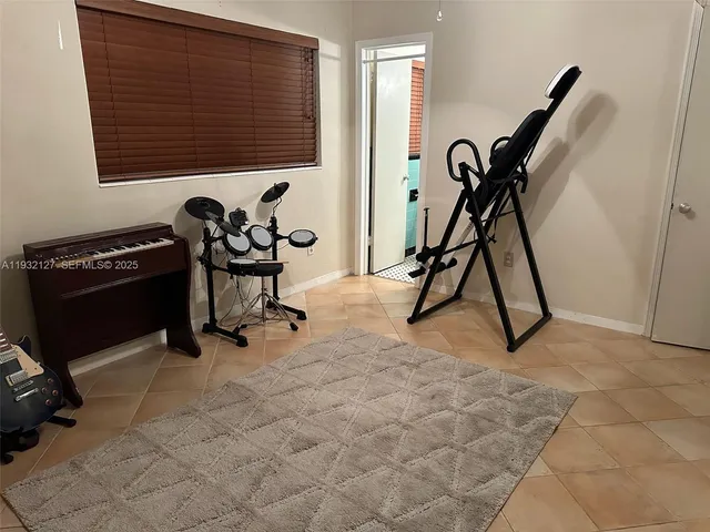 a room with gym equipment and white walls