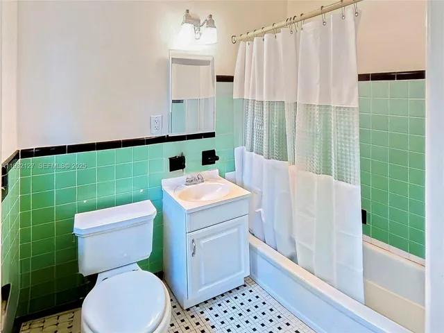 a bathroom with a toilet a sink and a shower