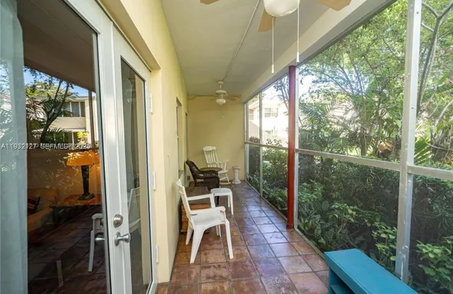 a porch with a table and chairs