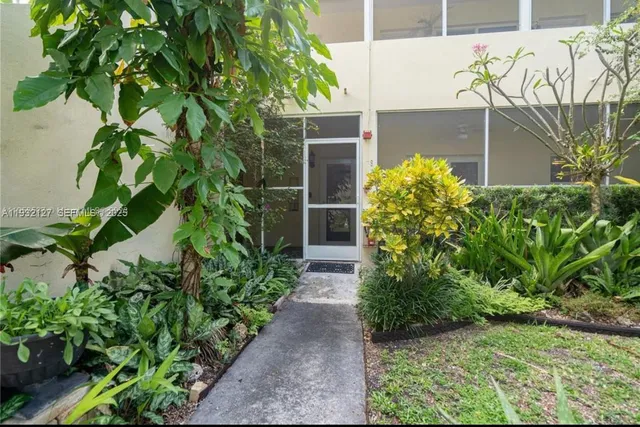 a view of a pathway with a flower plants