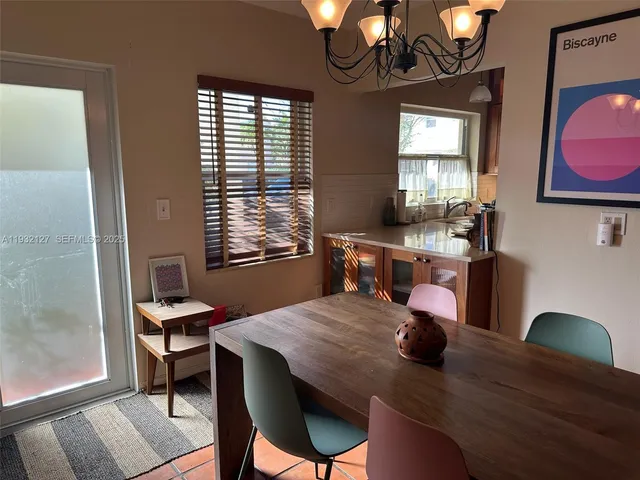 a view of a dining room with furniture and window