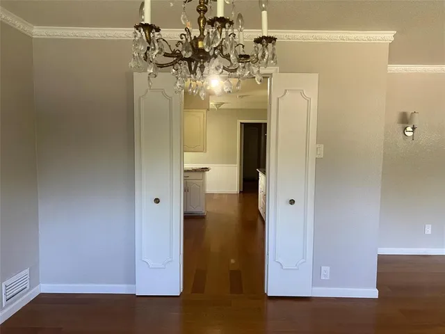 a view of a hallway with a chandelier