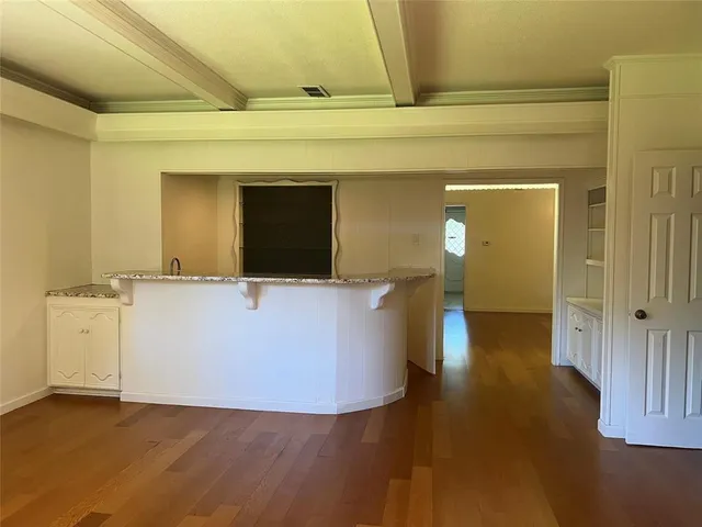 a view of a living room with a wooden floor