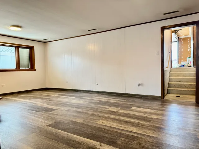 a view of a room with wooden floor