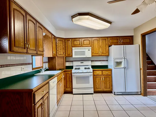 a kitchen with a stove a sink and a refrigerator