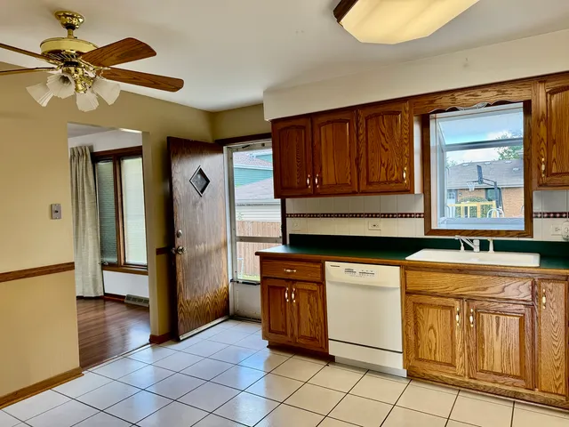 a kitchen with stainless steel appliances granite countertop a stove a refrigerator and a cabinets