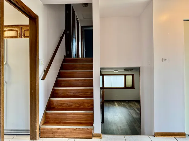 a view of staircase with wooden floor and a window