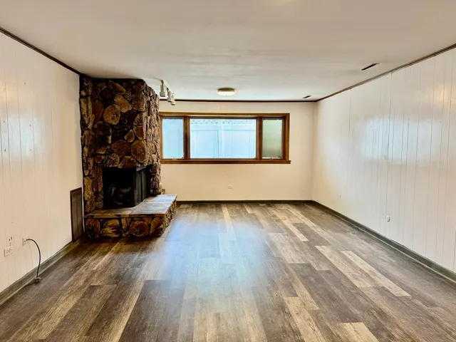 a view of an empty room and wooden floor