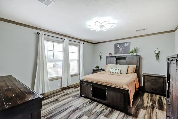 a bedroom with a large bed and a window
