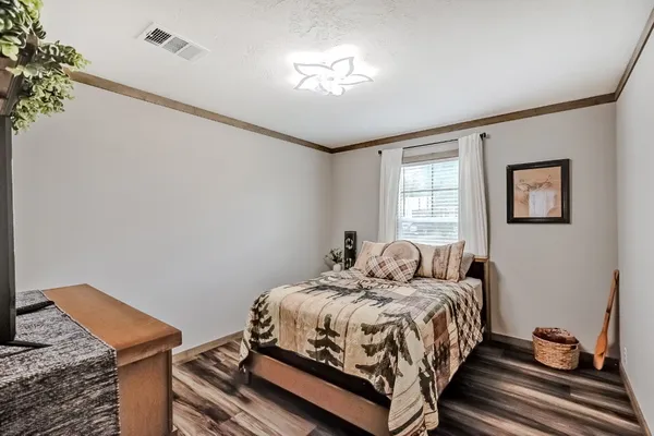 a bedroom with a bed and window