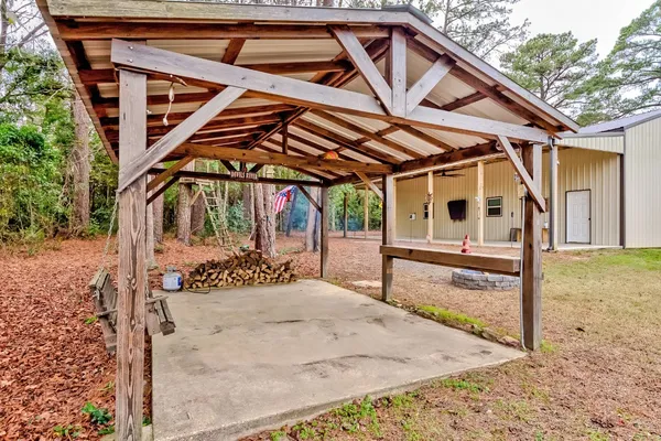a view of a white house with a big yard and large tree