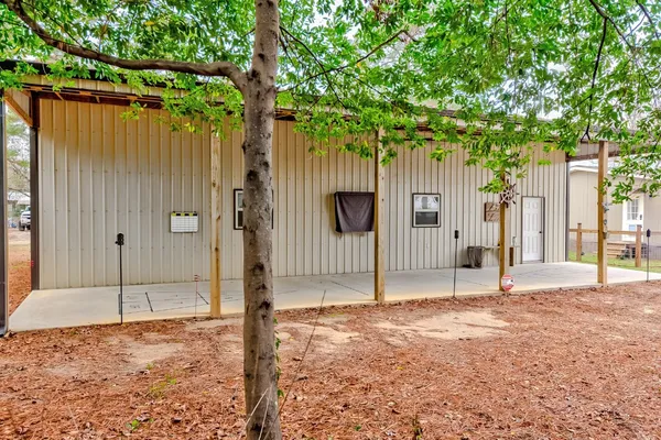 a backyard of a house with table and chairs