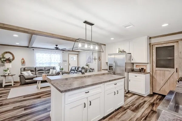 a large white kitchen with a large window