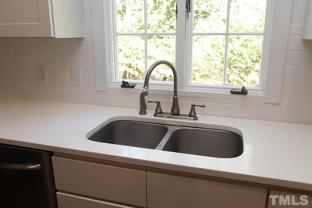3712 Pleasant Valley Road Raleigh, NC 27613 - Photo 12 of 32 a kitchen with a sink and a window