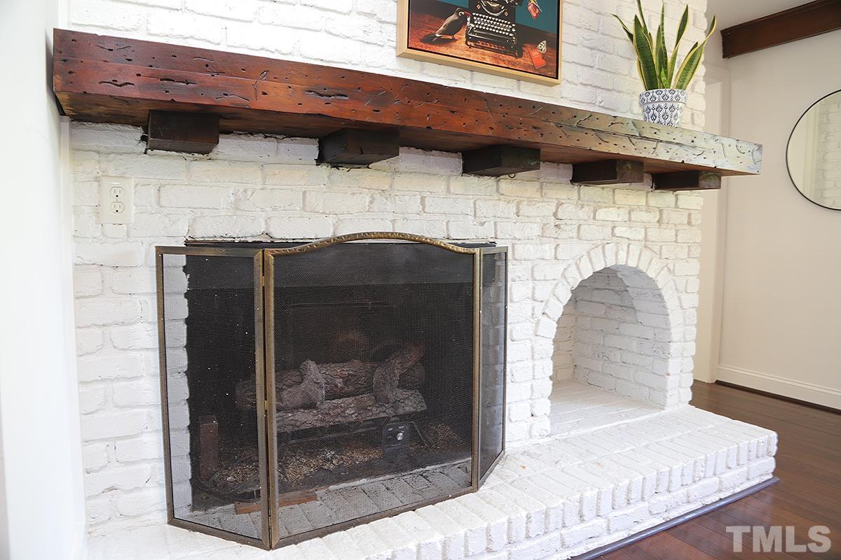 3712 Pleasant Valley Road Raleigh, NC 27613 - Photo 14 of 32 a view of a fireplace with a hallway