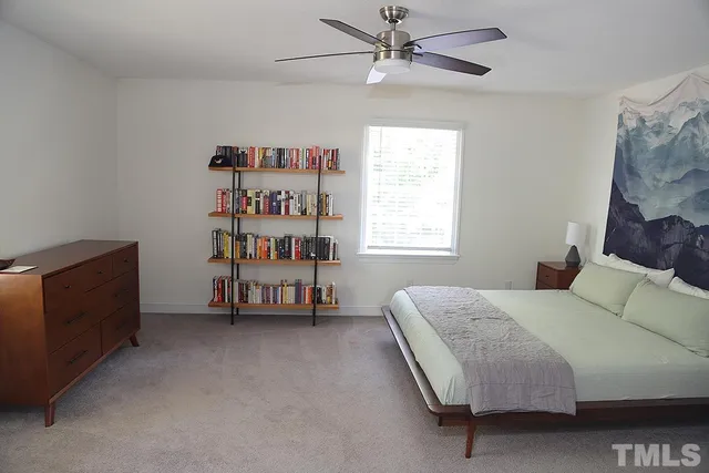 a bed room with a bed and a window