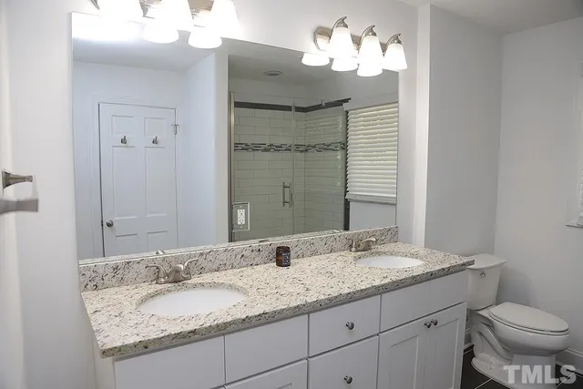 a bathroom with a glass shower door