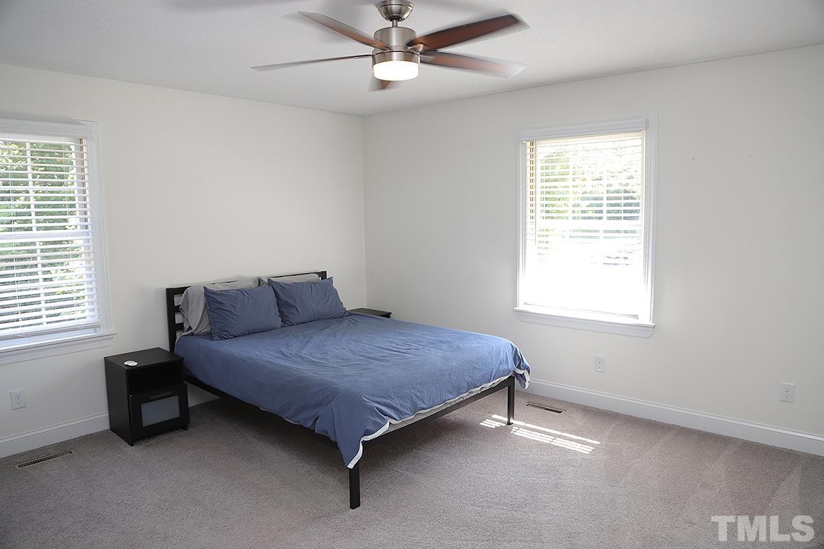 3712 Pleasant Valley Road Raleigh, NC 27613 - Photo 23 of 32 a bedroom with a bed and window