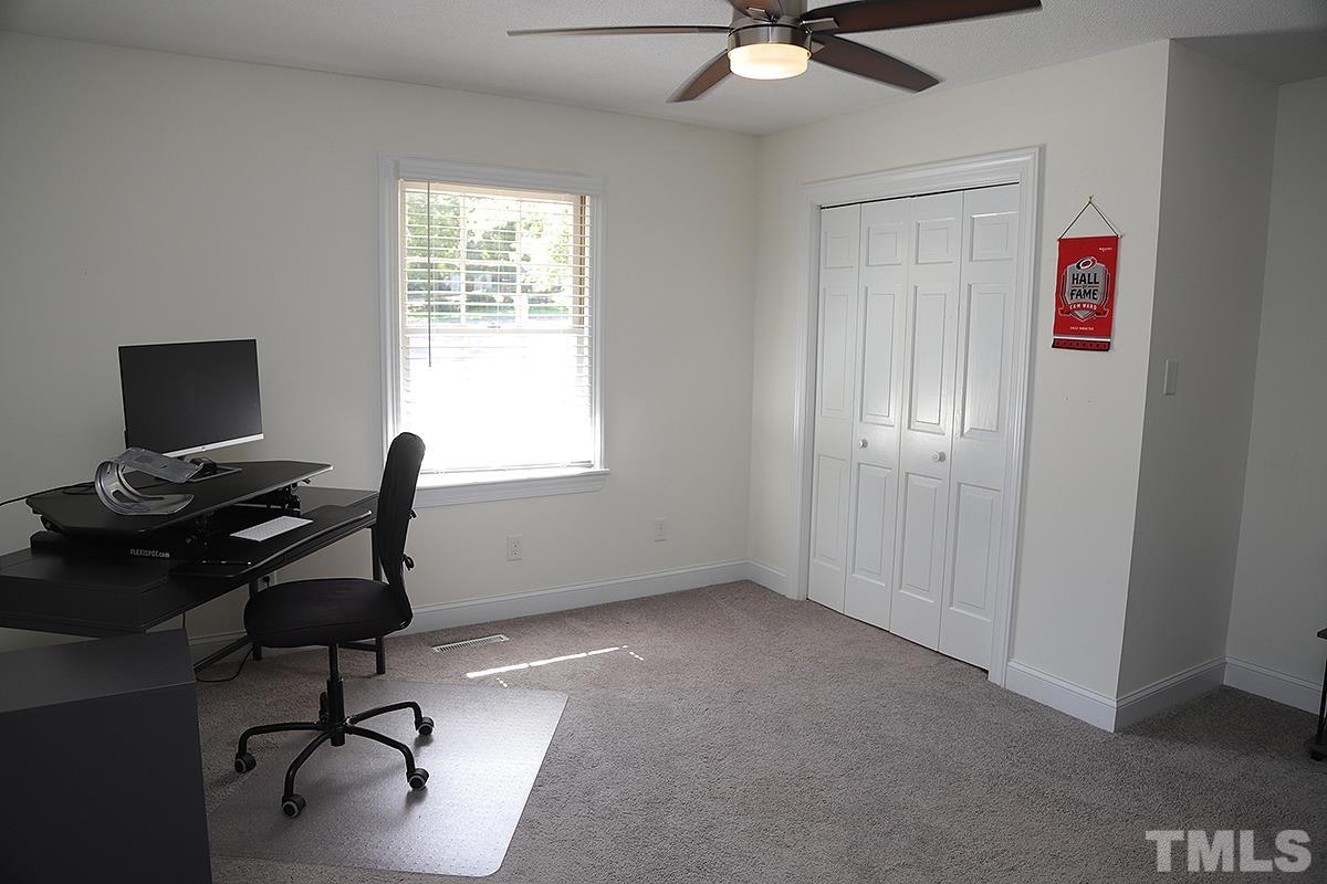 3712 Pleasant Valley Road Raleigh, NC 27613 - Photo 25 of 32 a view of a workspace with furniture and a window
