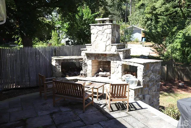 a view of a chairs and table in backyard