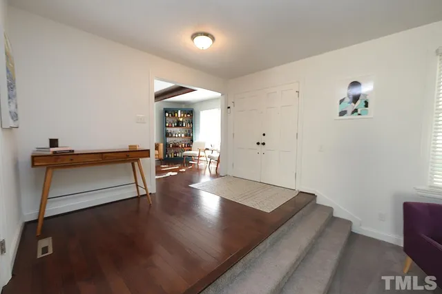 a living room with furniture a window and a flat screen tv