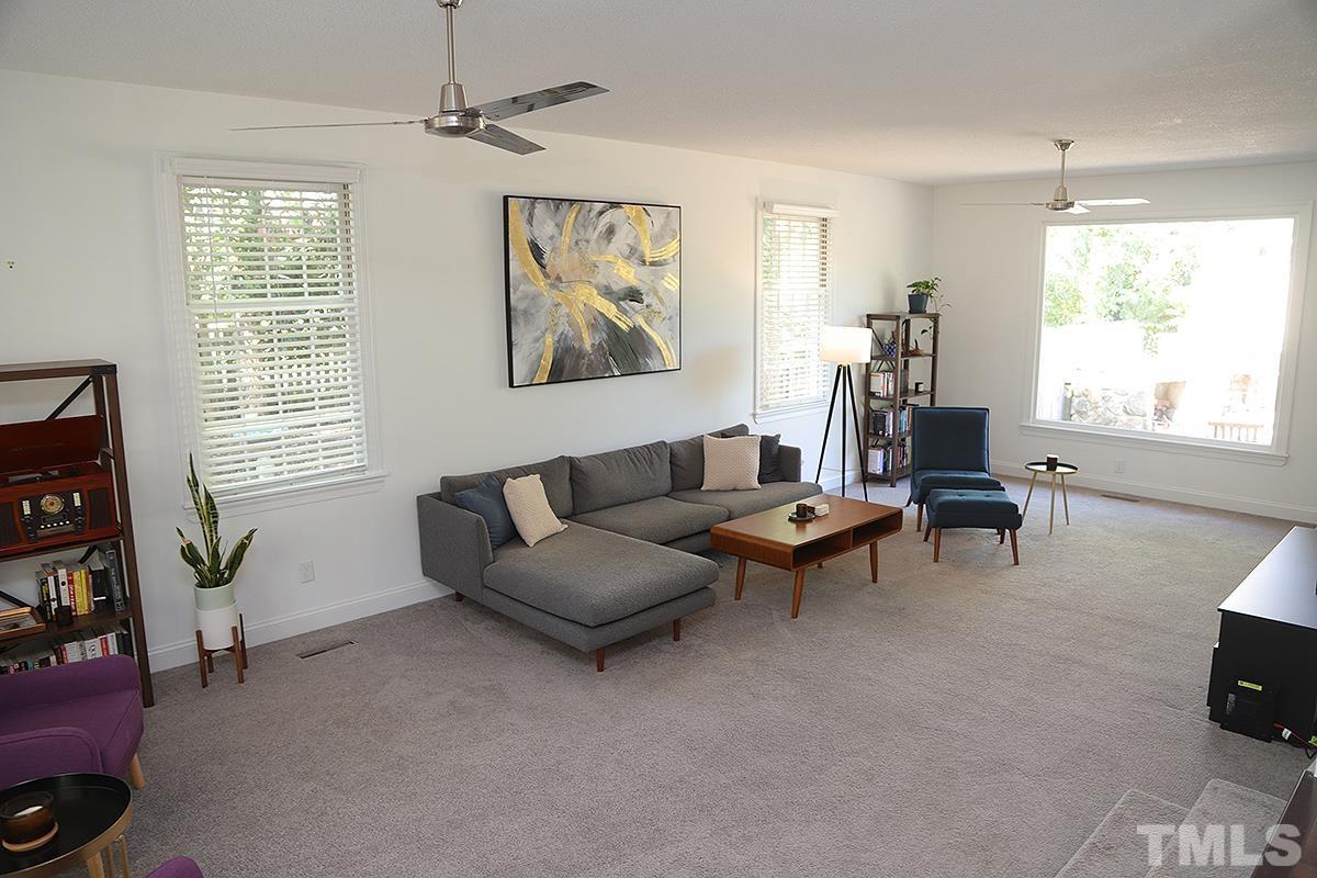 3712 Pleasant Valley Road Raleigh, NC 27613 - Photo 7 of 32 a living room with furniture a window and a flat screen tv
