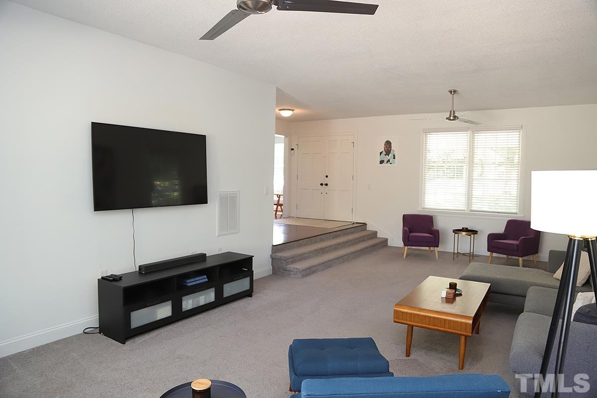 3712 Pleasant Valley Road Raleigh, NC 27613 - Photo 9 of 32 a living room with furniture and a flat screen tv