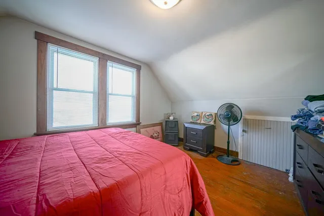 a bed sitting in a bedroom next to a window