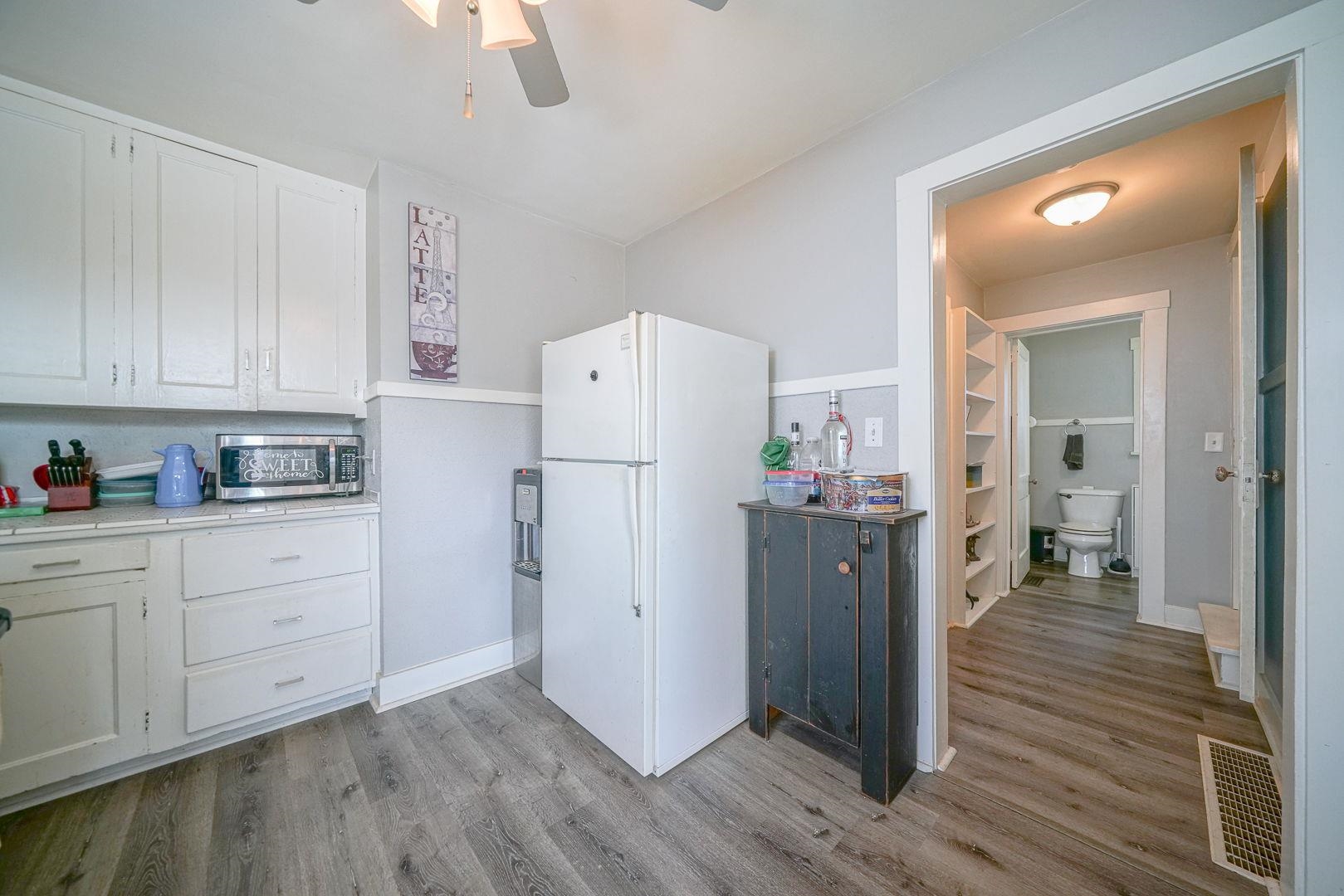 409 West Lincoln Street Mount Morris, IL 61054 - Photo 13 of 28 a kitchen with a refrigerator a stove and wooden floor