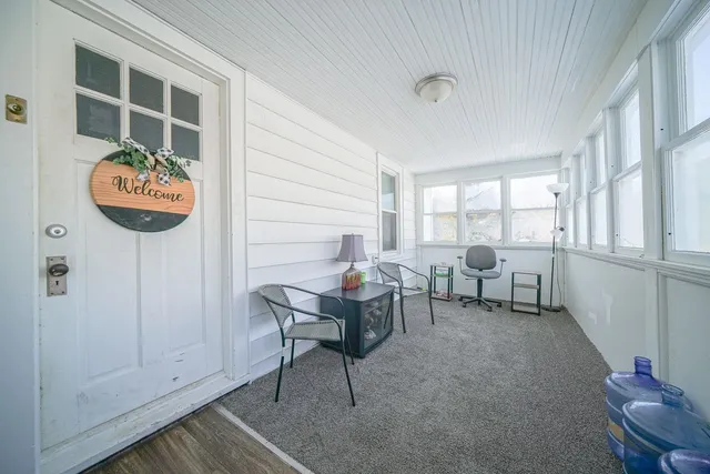 a view of a workspace with furniture and a window