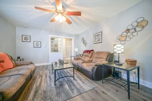 a bedroom with furniture and a wooden floor