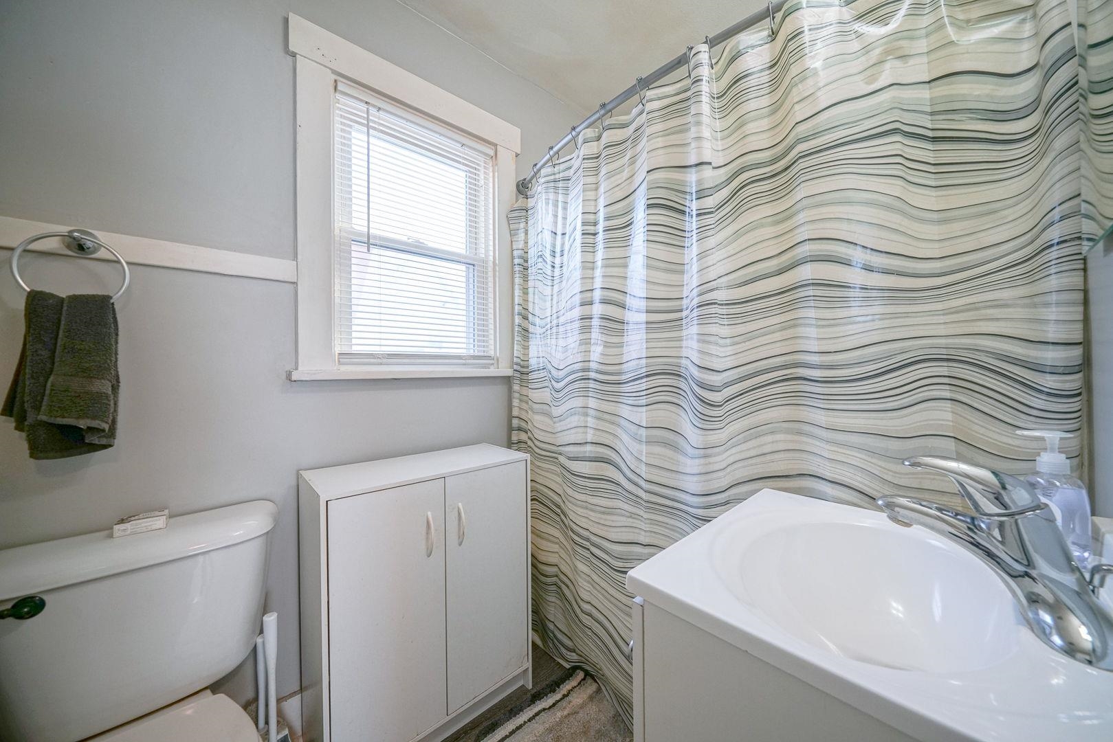 409 West Lincoln Street Mount Morris, IL 61054 - Photo 5 of 28 a bathroom with a sink a toilet and window
