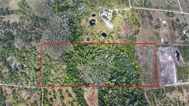 an aerial view of a houses with a yard