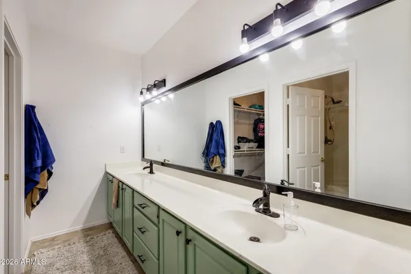 a bathroom with a double vanity sink and a mirror