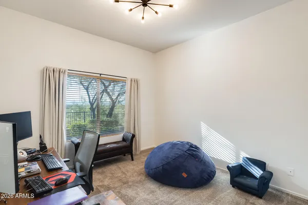 a bedroom with furniture and a large window