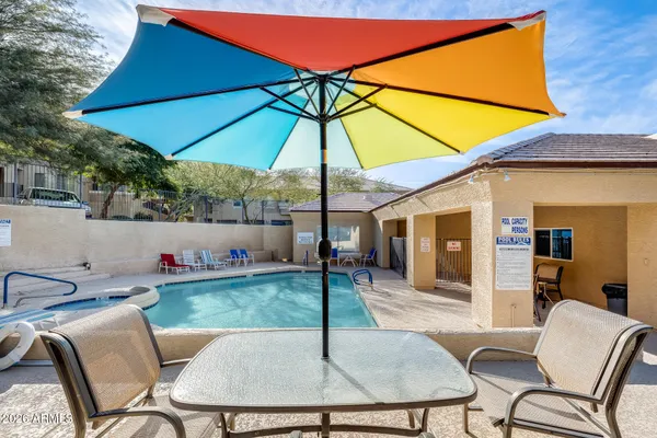 a backyard of a house with table and chairs
