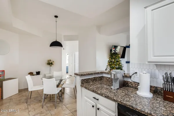 a kitchen with granite countertop a sink and potted plant