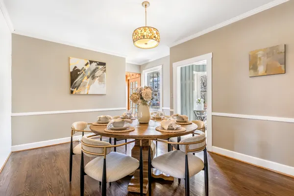a view of a dining room with furniture and chandelier