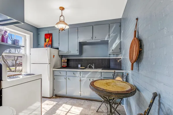 a kitchen with stainless steel appliances granite countertop a refrigerator and a stove