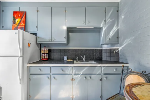 a kitchen with stainless steel appliances granite countertop a stove and a refrigerator