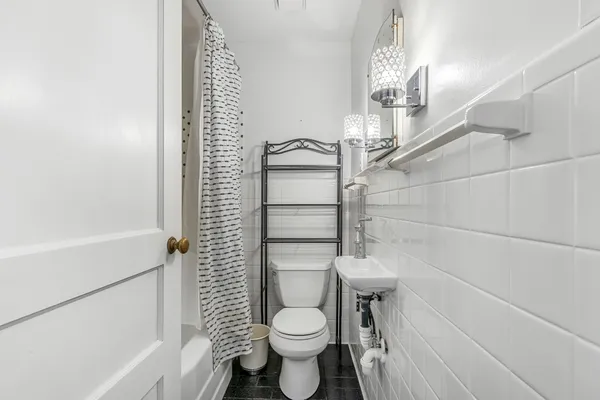 a living room with furniture a fireplace and a chandelier
