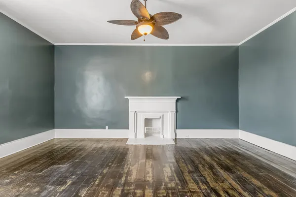 a view of a hallway with wooden floor and staircase