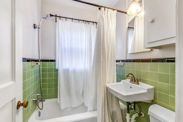 a kitchen with stainless steel appliances a stove a refrigerator white cabinets and a refrigerator