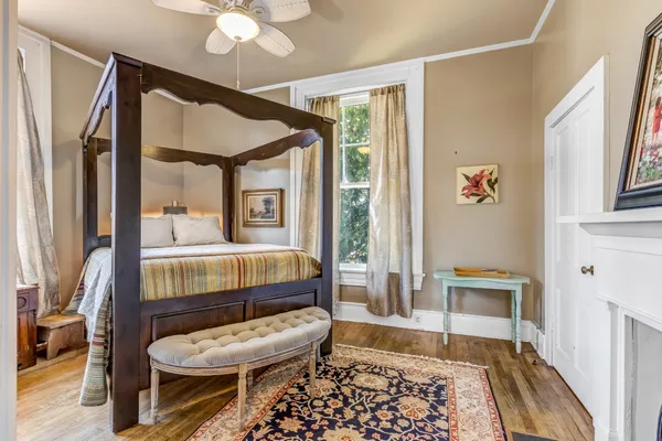 a bedroom with a bed and a fireplace