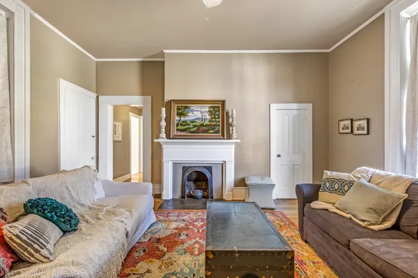 a living room with furniture chandelier and a table