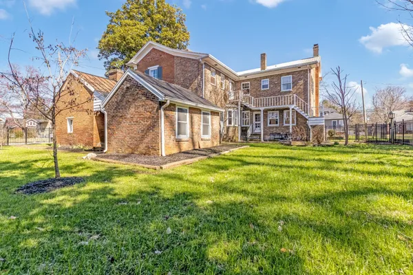 a view of a brick house with many windows