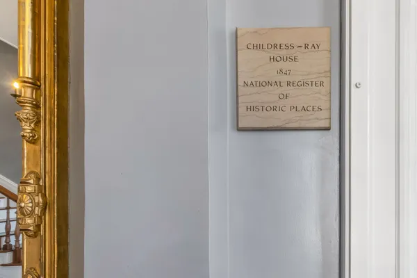 a sign on a wall next to a window